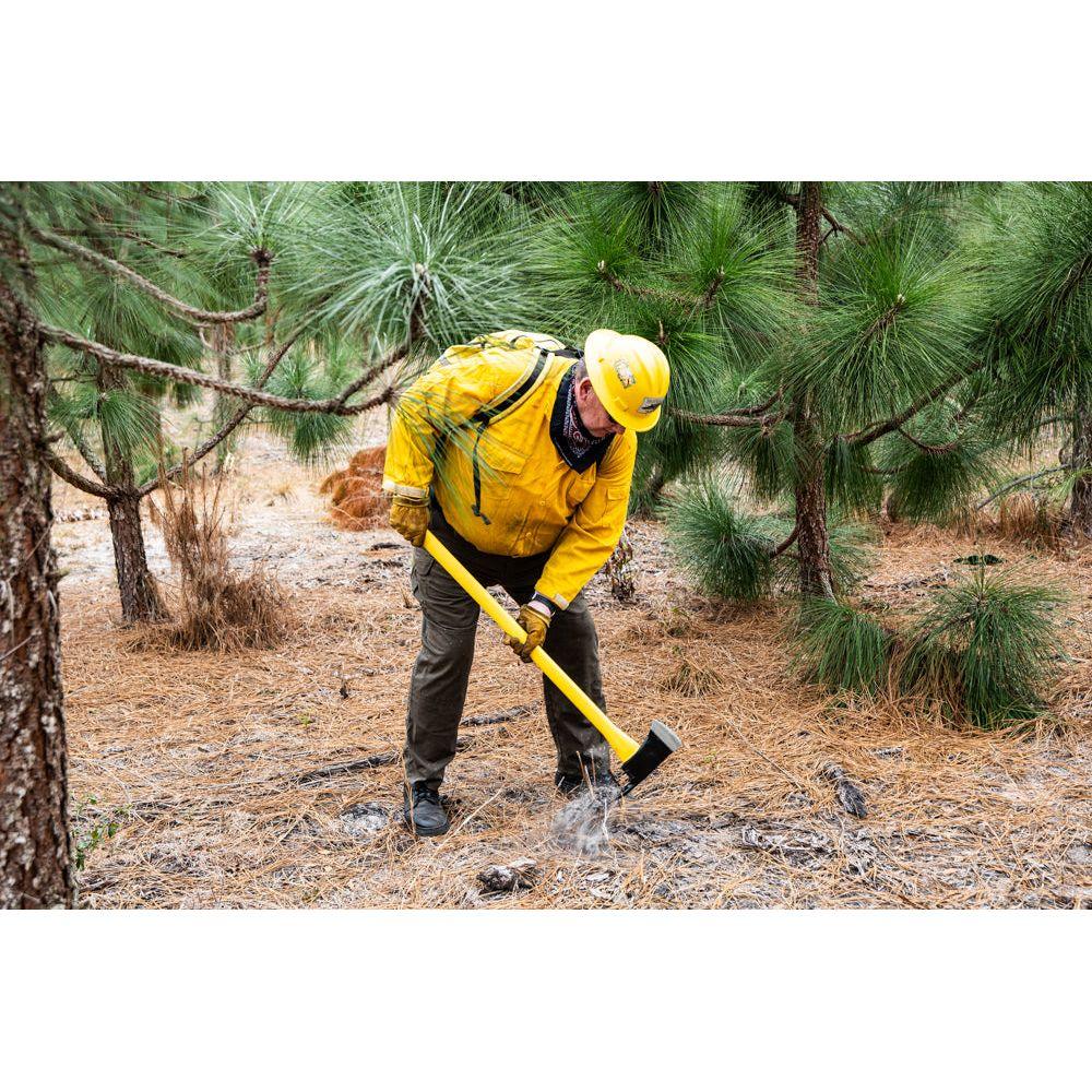 Firefighter working fireline with Pulaski